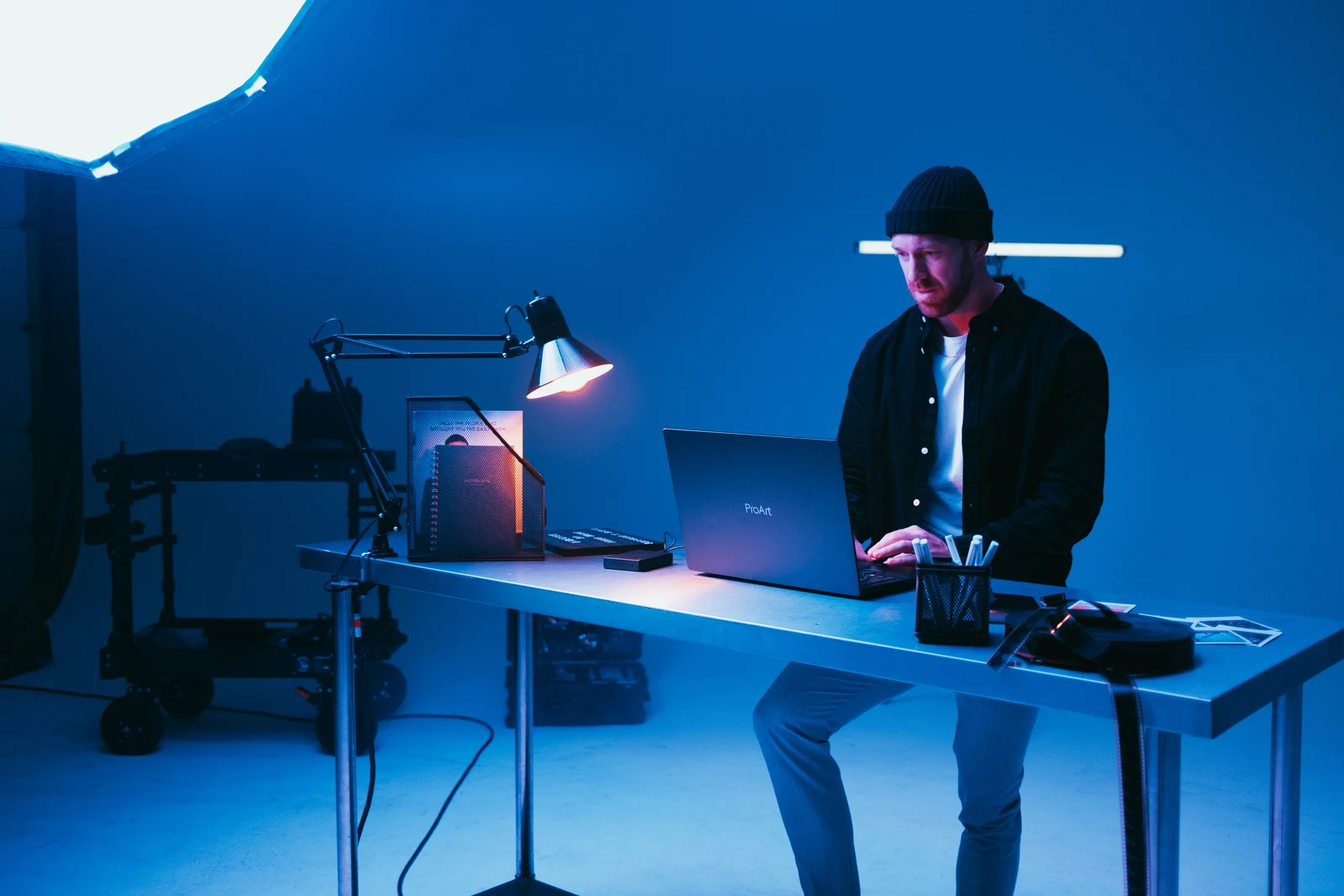 Photographer working with AI tools on laptop at their photography studio