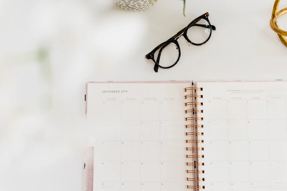 Monthly planner and calendar representing photography session scheduling and booking policy