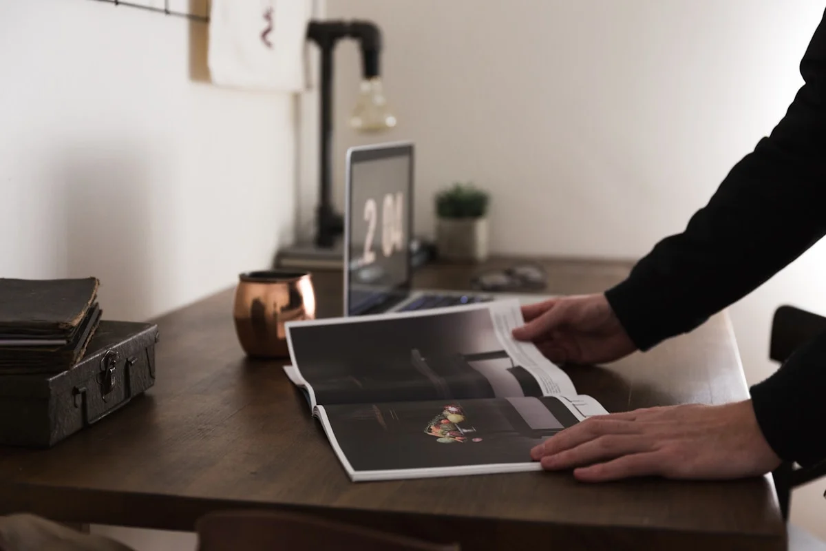 Photographer presenting fine art prints and albums to a client during an ordering session