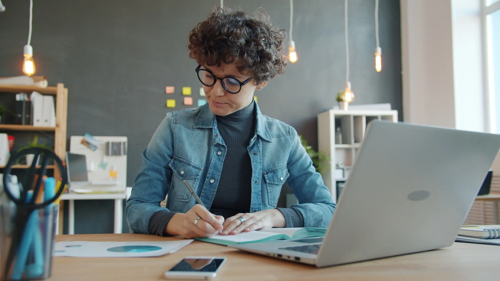Photographer working at desk with laptop planning business strategy
