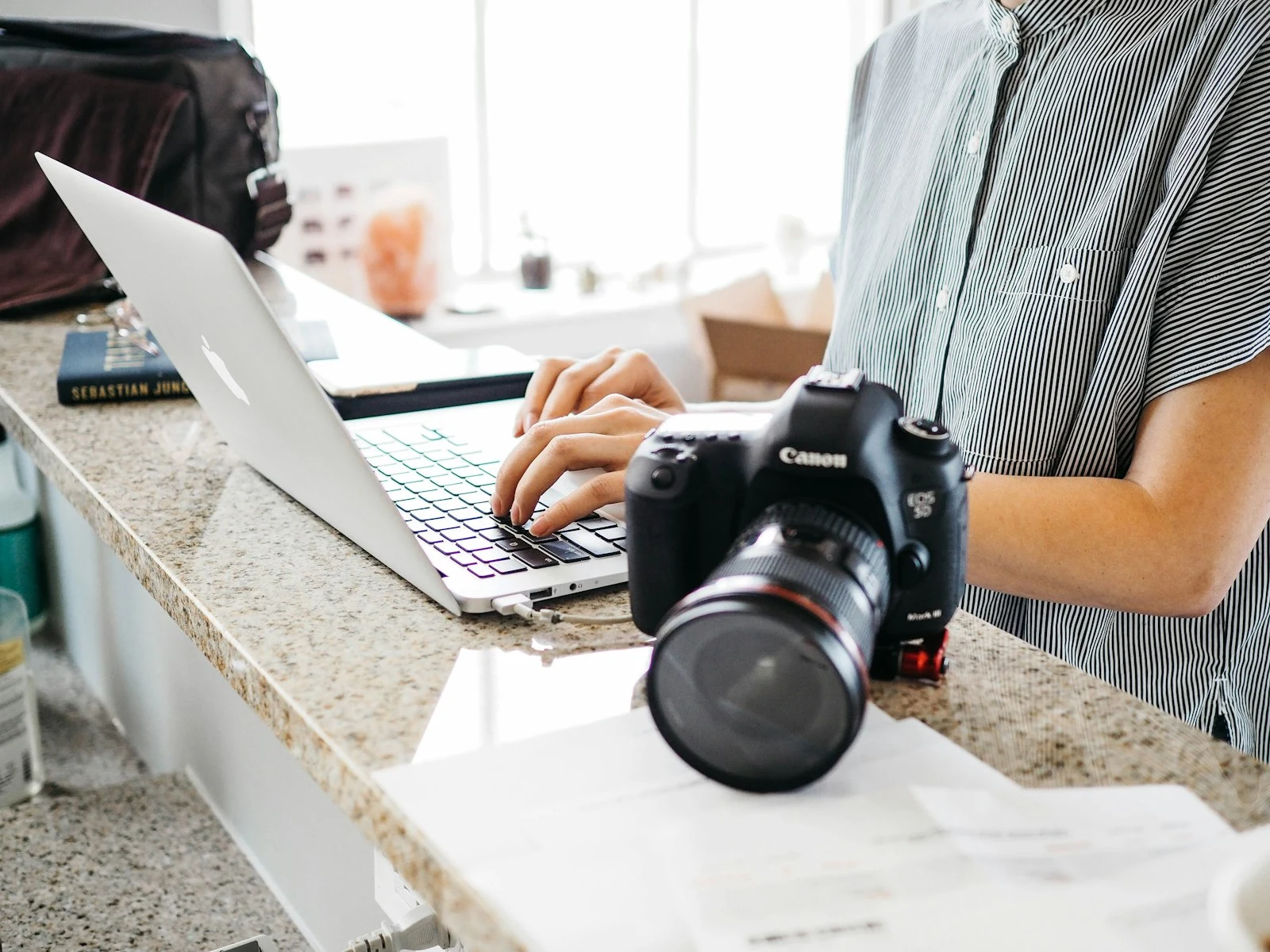 Photographer reviewing their portfolio website on a laptop